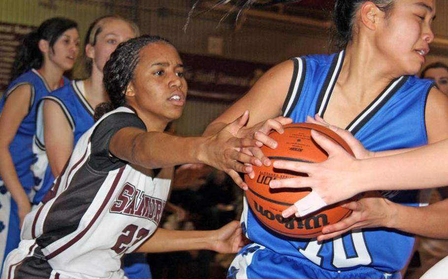 Rebekah Harwell of the Matthew C. Perry Samurai tries to strip the ball from Erika Ettl of the Yokota Panthers during Friday's DODDS Japan girls basketball game at Matthew C. Perry High School, Japan. The Panthers won 60-53.