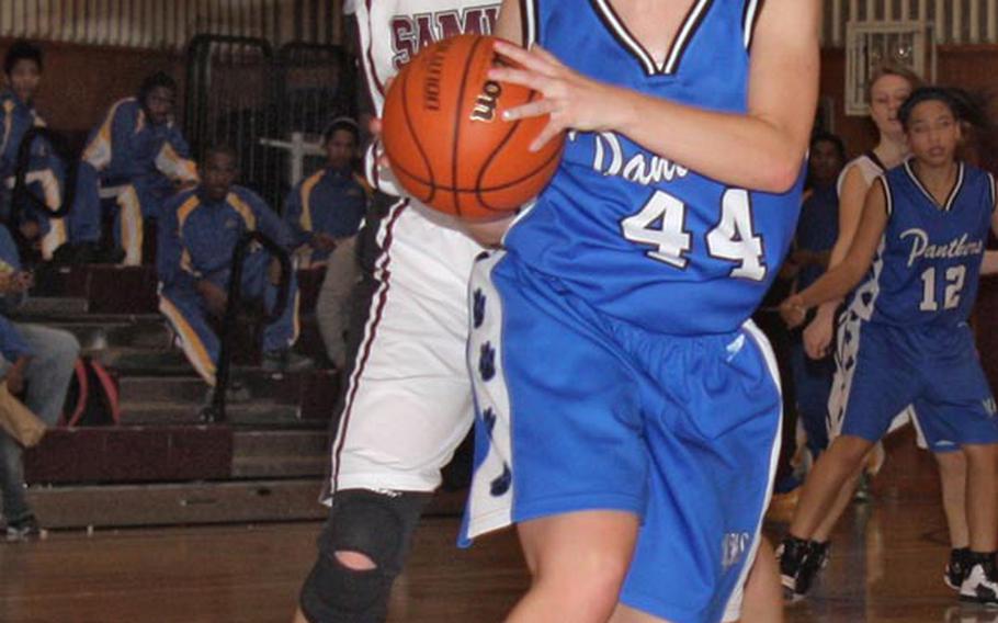 Kathryn White of the Yokota Panthers looks to pass as Courtney Beall of the Matthew C. Perry Samurai defends during Friday's DODDS Japan girls basketball game at Matthew C. Perry High School, Japan. The Panthers won 60-53.