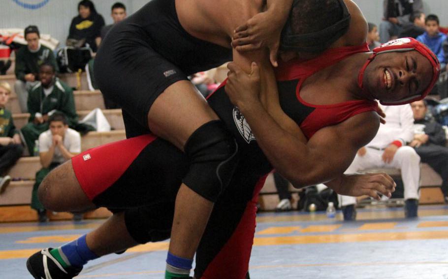 180-pounder Darnell Vinson, right, of E.J. King twists Zama American's Mitchell Harrison toward the mat during Saturday's title in the DODDS Japan Wrestling Tournament at Yokota High School. Vinson won by decision. Zama finished fourth in the tournament with 29 points; the Cobras placed fifth with 17.