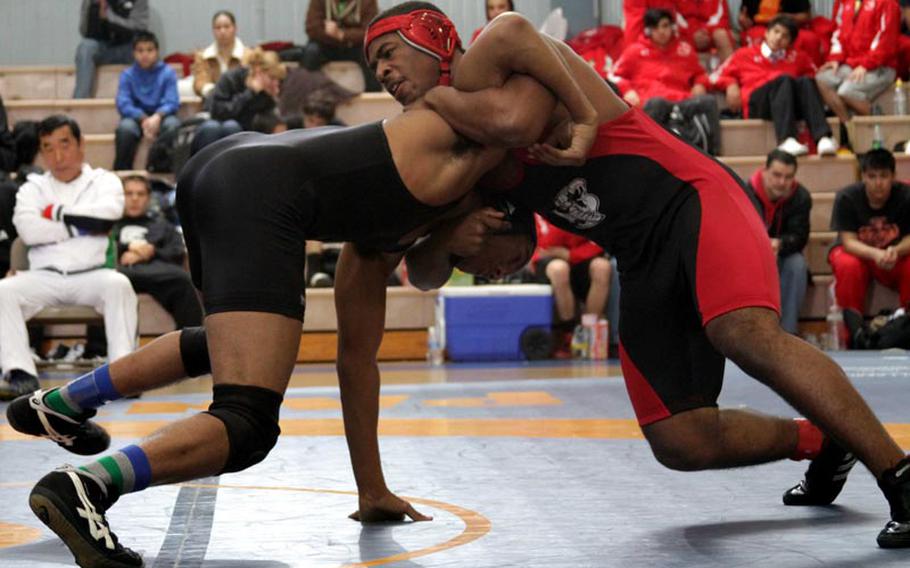 180-pounder Darnell Vinson, right, of E.J. King battles Zama American's Mitchell Harrison during Saturday's title bout in the DODDS Japan Wrestling Tournament at Yokota High School. Vinson won by decision. Zama finished fourth in the tournament with 29 points; the Cobras placed fifth with 17.