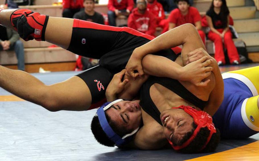 158-poundes Alex Banks of Nile C. Kinnick and Hiro Takahashi of Yokota tangle during Saturday's gold-medal bout in the DODDS Japan Wrestling Tournament at Yokota High School. Banks won by pin, but Yokota won the team title with 61 points to 44 for Kinnick.