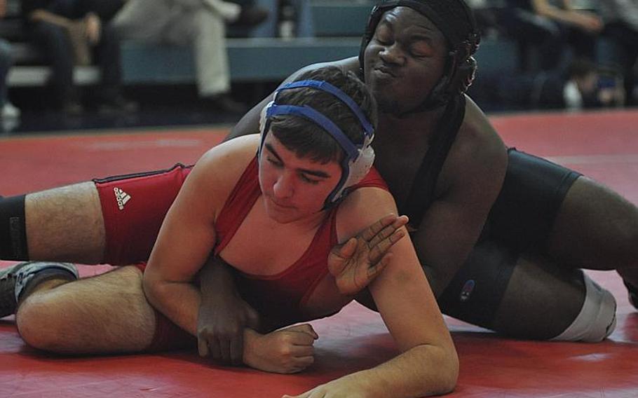 Vicenza's Malcolm Dorsey, right, went on to defeat Aviano's Noah Wolton at 220 pounds.