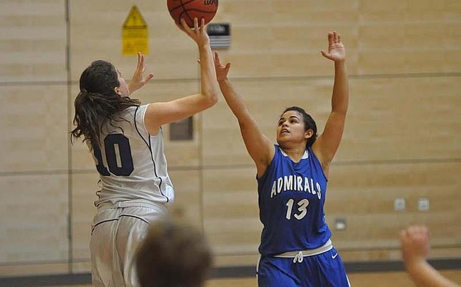 Ali DeFazio of Brussels attempts a desperation shot over Yesenia Solis of Rota in the final second of Rota's Division III semifinal win over the Lady Brigands 22-19 Friday at Wiesbaden High School.