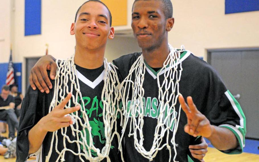 Kubasakiseniors B.J. Simmons and Brandon Crawford display the souvenir net cords and indicate two for back-to-back titles after the championship game of the 63rd Far East High School Boys Division I Basketball Tournament at Naval Station, Guam. Kubasaki defeated Okkodo of Guam 55-47 for its second straight title, its third in six years under coach Jon Fick and its Pacific-record 11th.