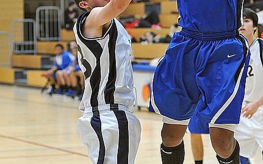 Rota's Tre'von Owens shoots over Tyler Storms of Lajes at the 2012 DODDS-Europe basketball championships. Owens has been selected as the Stars and Stripes boys basketball player of the year for the second consecutive year.