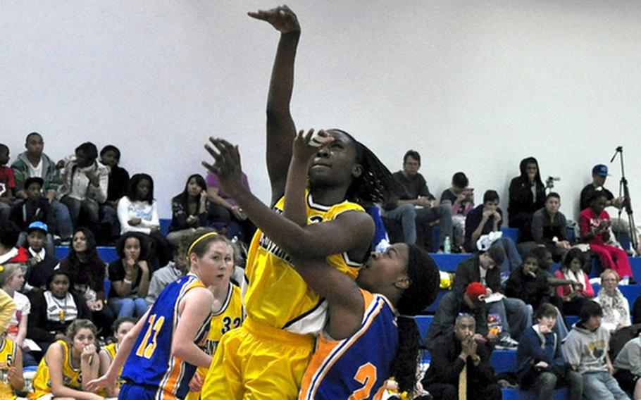 Janelle Loney goes in for a layup during a game against Wiesbaden in December. Loney has been selected as the Stars and Stripes girls basketball player of the year for the second consecutive year.