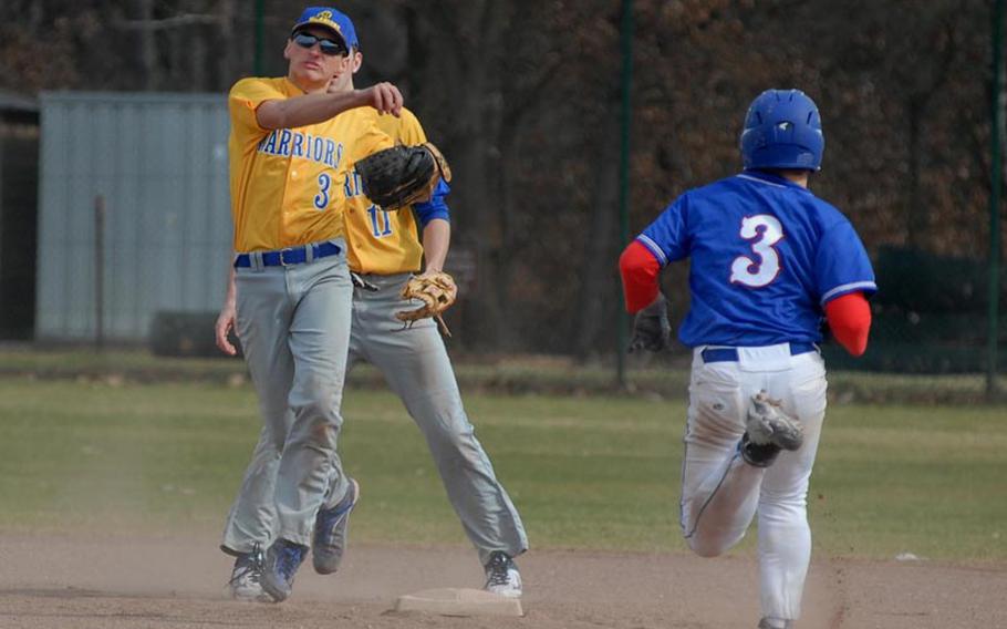 Wiesbaden senior Dan Aslakson tries to convert the double play as Ramstein sophomore Matt Sharpy charges to second base Saturday. The Royals swept a doubleheader against the Warriors at Ramstein Air Base.