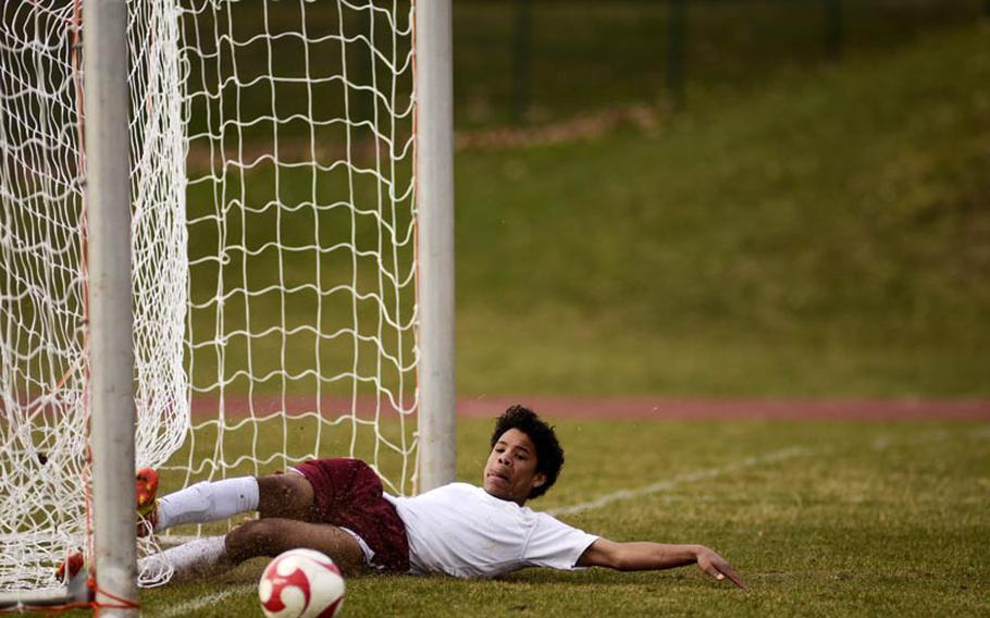 Baumholder's Devon Farmer slides to knock the ball out of the goal as SHAPE was inches away from scoring another goal in Saturday's game in Baumholder, Germany. SHAPE won the game 8-0.