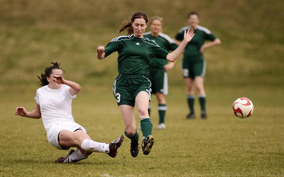 Baumholder's Makenzie Ehrhardt takes an athletic shot on goal against SHAPE's Allyson Kulmayer in Saturday's game in Baumholder, Germany. Ehrhardt scored Baumholder's only goal as SHAPE won the game 8-1.