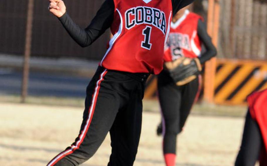 E.J. King shortstop Carmela Lucey leaps for a Nile C. Kinnick Red Devils line drive during Saturday's championship game in the DODDS Japan girls softball tournament at Yokota Air Base. The Red Devils edged the Cobras 9-8 for the title.