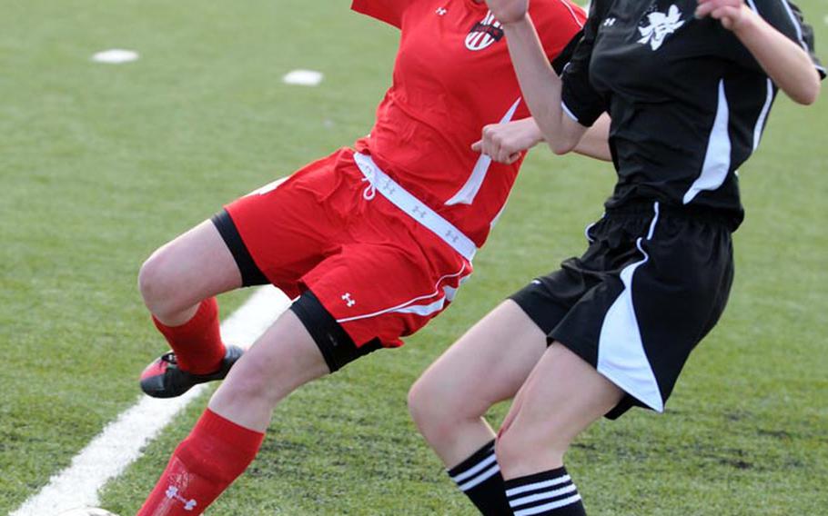 Nile C. Kinnick sweeper Kayla Forsythe, left, and Matthew C. Perry's Ghia Ulrey battle for the ball during Saturday's match in the DODDS Japan girls soccer tournament at Yokota Air Base. Kinnick blanked Perry 2-0.