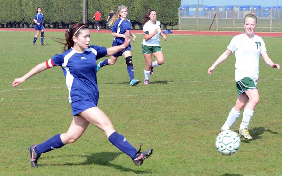 Bitburg junior Averi Goetz sends a shot to the back of the net Saturday for one of her two goals in the match against Alconbury. Dragon defender Livana Gross watches the shot. The Lady Barons won the match 2-0.