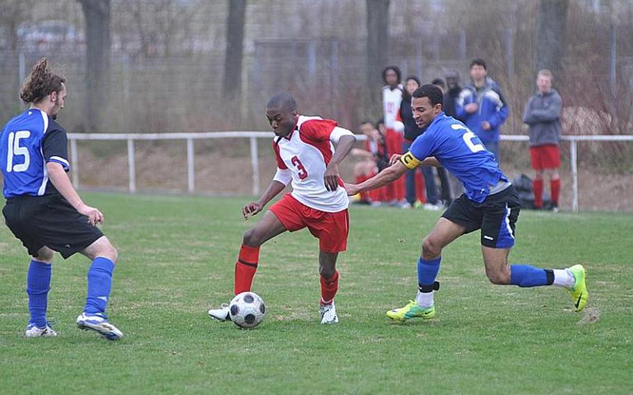 Marquis Doctor-Smith of Schweinfurt dribbles by Hohenfels Xavier Davis, rigth, and Patrick Vass on Saturday during the Hohenfels Tigers' 2-1 win over the Razorbacks.