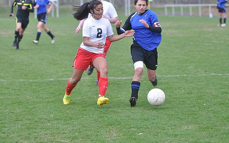Mariah Ormita, left, of Schweinfurt battles for a loose ball with Alexis Perryman of Hohenfels Saturday during Schweinfurt's 5-1 win over the visiting Lady Tigers.