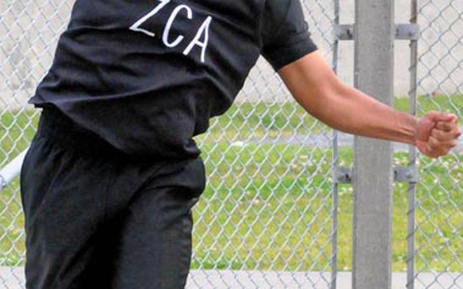 Craig Hollins of Zion Christian Academy, Okinawa, cuts loose in the shot put on Friday in the 9th Alva W. "Mike" Petty Memorial Track & Field Meet at Camp Foster, Okinawa. Hollins won with a throw of 40 feet, 9 inches.