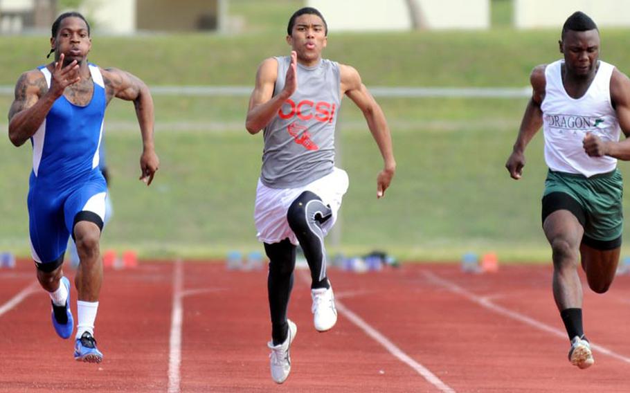Seoul American's Tyrend White, from left, Okinawa Christian International's Rahman Cairnes and Kubasaki's Jarrett Mitchell race for the tape in the boys 100-meter final during Saturday's running finals in the 9th Alva W. "Mike" Petty Memorial Track and Field Meet at Camp Foster, Okinawa. Cairnes won the event in 11.23 seconds, followed by Mitchell (11.31) and White (11.43).