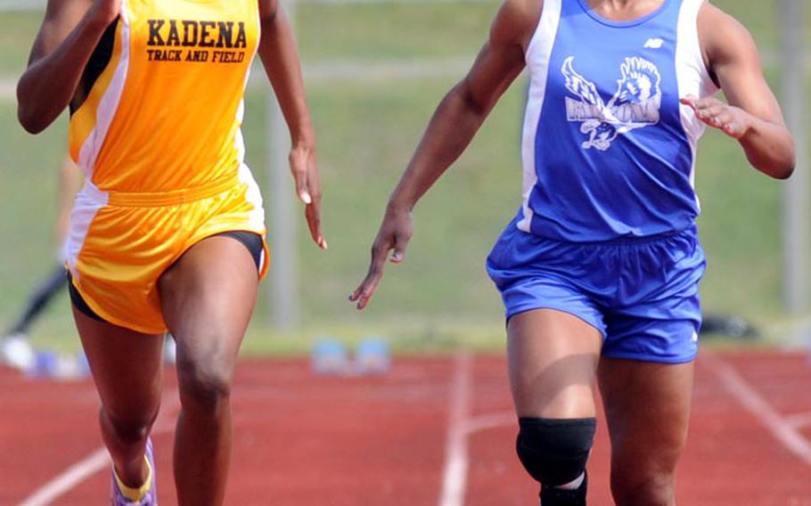 Kadena's Janika Caines and Seoul American's Kelsey Scott go neck-and-neck for the tape in the 100-meter final during Saturday's running finals in the 9th Alva W. "Mike" Petty Memorial Track and Field Meet at  Camp Foster, Okinawa. Caines edged Scott by two-hundredths of a second and set the meet record with a time of 12.66 seconds, nine-hundredths better than Scott ran in qualifying on Friday.