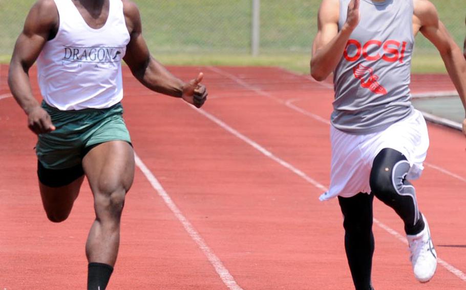 Sprinters Jarrett Mitchell of Kubasaki and Rahman Cairnes of Okinawa Christian International race for the finish of the 200-meter dash during Saturday's running finals in the 9th Alva W. "Mike" Petty Memorial Track and Field Meet at Camp Foster, Okinawa. Cairnes edged Mitchell, 22.84 seconds to 23.08.