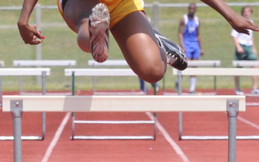 Pashence Turner of Kadena negotiates the final hurdle in the 300-meter hurdles during Saturday's running finals in the 9th Alva W. "Mike" Petty Memorial Track and Field Meet at Camp Foster, Okinawa. Turner beat her own meet record in the event, clocking 48.43 seconds on Saturday, beating her Friday qualifying time of 49.13.
