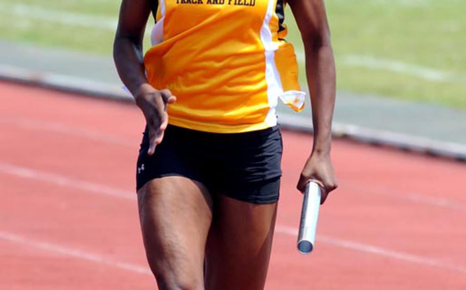 Kadena's Janika Caines carries the baton home in the girls 400-meter relay during Saturday's running finals in the 9th Alva W. "Mike" Petty Memorial Track and Field Meet at Camp Foster, Okinawa. Kadena's girls set a meet record with a time of 51.54 seconds, topping the old mark of 52.38 set two years ago, also by Kadena.