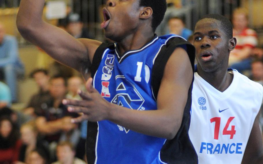 Derrick Walton Jr. of the U.S. gets past France's Mouhamadou Jaiteh for two of his 20 points in the Americans' 87-81 victory over France at the Albert Schweitzer Tournament in Mannheim, Germany, Saturday.