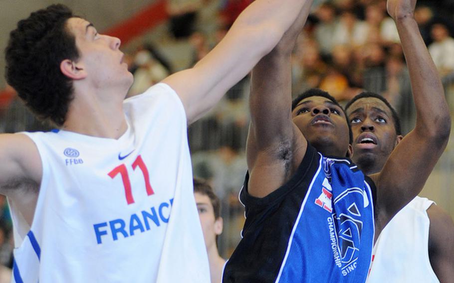 Stevie Clark  of the U.S. shoots over France's Tristan Toneguzzo for two of his four points in the U.S.'s 87-81 victory over France at the Albert Schweitzer Tournament in Mannheim, Germany, Saturday.