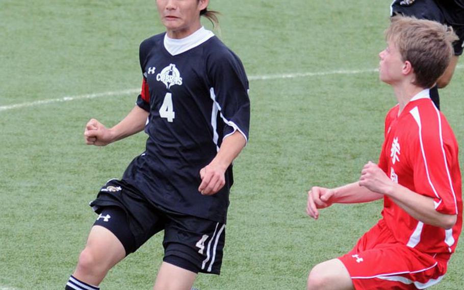 E.J. King's Paul Asyn heads the ball against Nile C. Kinnick's Joey Marino during Friday's DODDS Japan soccer match at Kuga Field, Japan. Kinnick won 2-0.