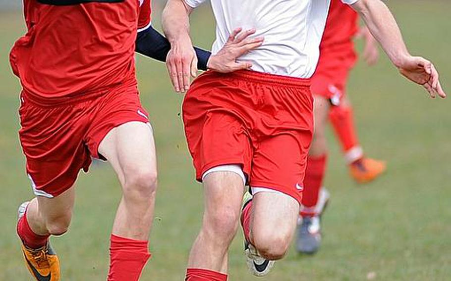 Alessandro Pryce of International School of Brussels, left, and Kaiserslautern's Erik Langholz fight for the ball in a game in Kaiserslautern, Saturday. The game ended in a 1-1 tie.