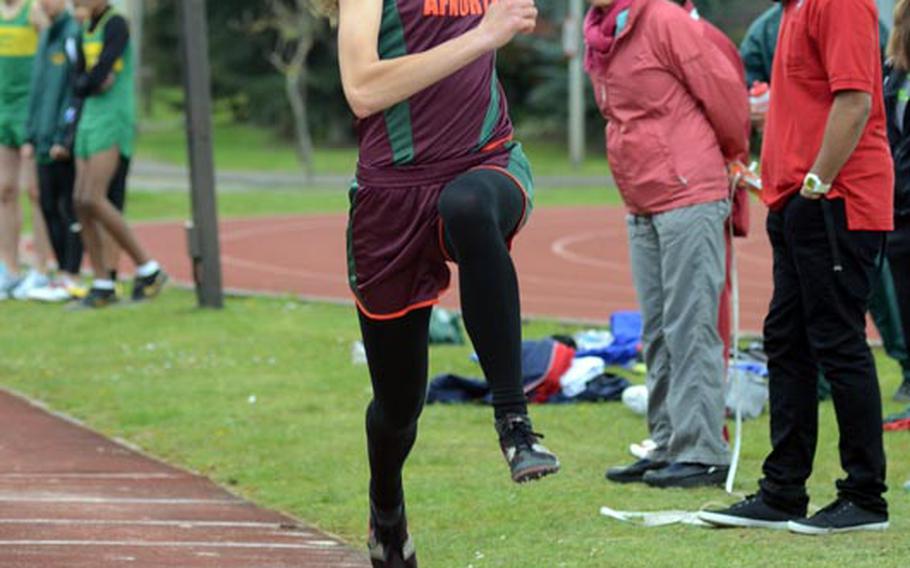 AFNORTH's Sara Sawyer, a senior, eyes her landing spot in the sand on her way to a triple jump of 33-feet, five inches during a track meet at RAF Lakenheath, England, on Saturday. Sawyer finished first in the triple jump and long jump.