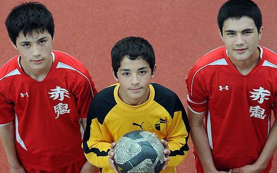 Three Nile C. Kinnick brothers, from left, sophomore midfielder Branden Yoder, freshman goalkeeper Brady Yoder and junior forward Zach Yoder have helped the Red Devils to their best start in six years.