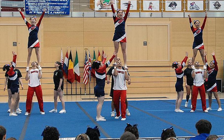 Darien Cornett, center, and the Aviano Saints cheer squad in action at the DODDS-Europe cheerleading championships in Wiesbaden in February. The Saints took third in Division II and Cornett was selected to the All-Europe team.