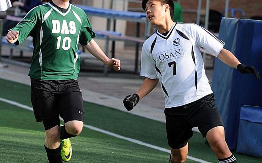 Min Su Kim of Osan American heads the ball next to River Shank of Daegu during Friday's opening match in the Korean-American Interscholastic Activities Conference Boys Division I Soccer Tournament at Gyeonggi Suwon International School, South Korea. Osan won 1-0.