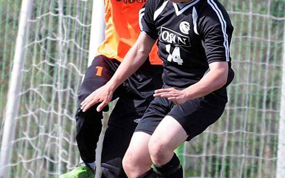 Tyrone Boylan of Osan American bangs into Gyeonggi Suwon International goalkeeper Tim Lim during Friday's quarterfinal match in the Korean-American Interscholastic Activities Conference Boys Division I Soccer Tournament at Gyeonggi Suwon International School, South Korea. The Knights won 5-0.