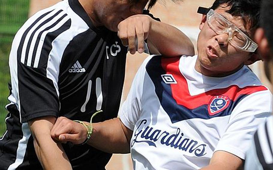 Hee Min Byun of Taejon Christian International collides with Thomas Kim of Yongsan International-Seoul as Kim heads the ball during Friday's quarterfinal match in the Korean-American Interscholastic Activities Conference Boys Division I Soccer Tournament at Gyeonggi Suwon International School, South Korea. The Guardians won 4-2.