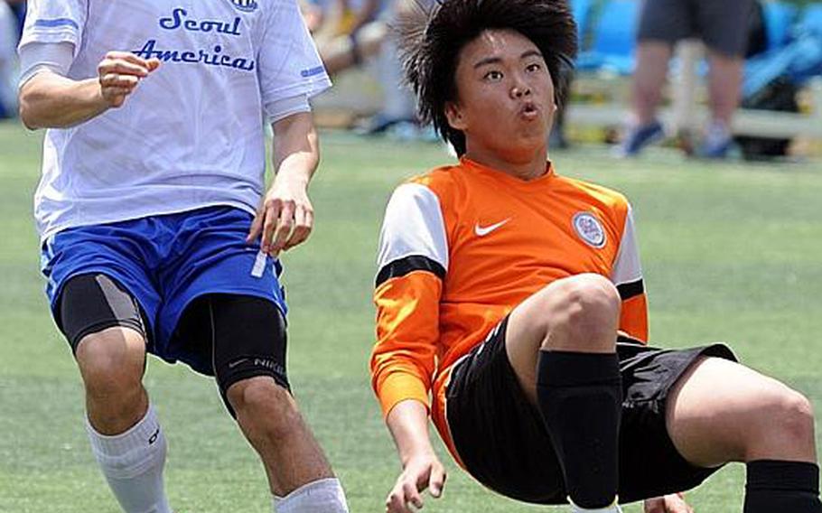 Sam Woo, right, of Seoul International readies a bicycle kick as Seoul American's David Voelker pursues during Friday's quarterfinal match in the Korean-American Interscholastic Activities Conference Boys Division I Soccer Tournament at Gyeonggi Suwon International School, South Korea. The Falcons won 3-2.
