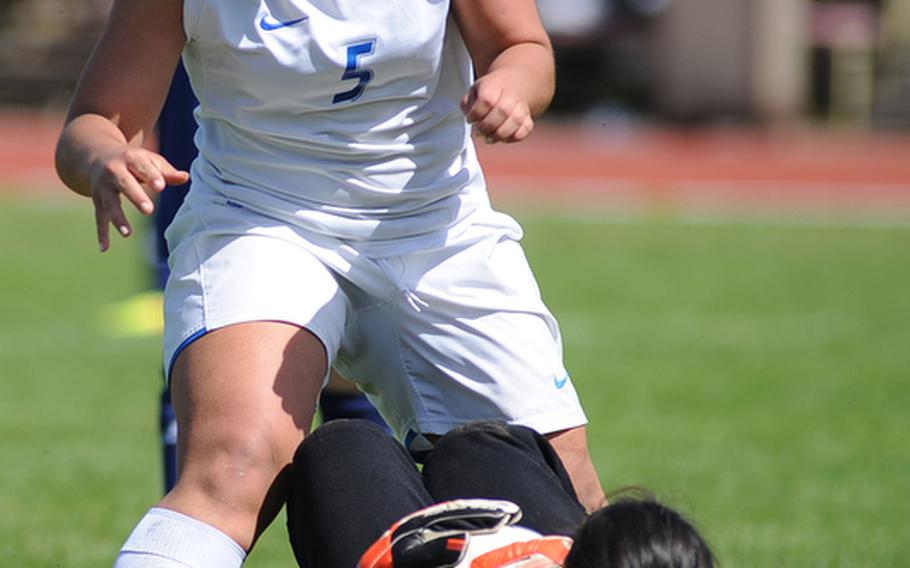 Bitburg keeper Isabella Madamba pulls in the ball before a charging Mimi Rivera of Ramstein can get to it. Ramstein beat Bitburg 10-0 at home, Saturday.