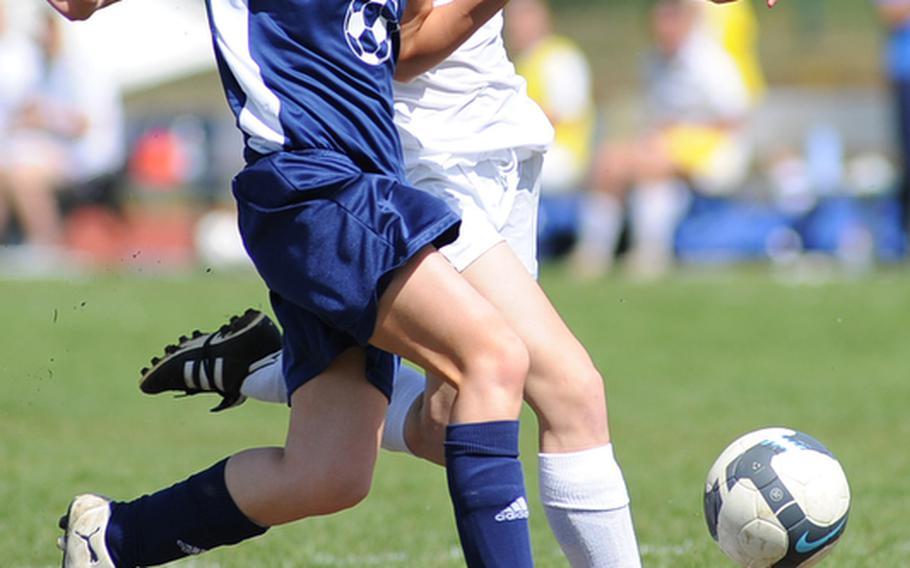 Bitburg's Taylor Mynderup, left, tries to block a shot by Ramstein's Dominique DuBois in a game at Ramstein, Saturday. The home team won 10-0.