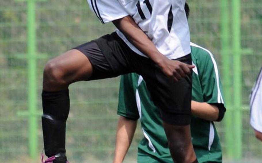 Menasseh Nartey of Osan American heads the ball against Daegu during Saturday's placement match in the Korean-American Interscholastic Activities Conference Boys Division I Soccer Tournament at Suweon, South Korea. The Cougars won 3-0.