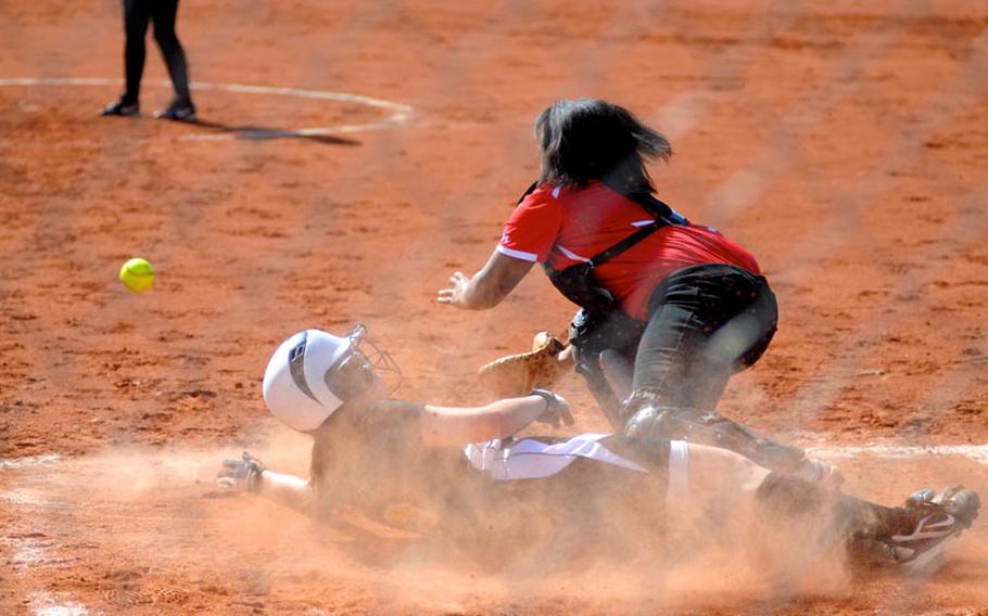 Patch's Paige Miller slides safely into home as Schweinfurt's Brattany Waters reaches for the ball during the first game of a doubleheader Saturday at Patch Barracks.