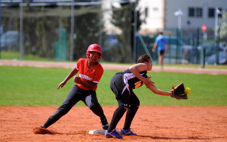 Leah Rogers arrives safely on base as Caitlyn Steffen catches the ball during the first of a doubleheader Saturday at Patch Barracks.