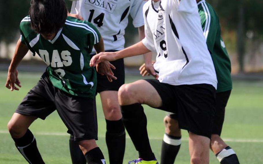Carlo Bonifacio of Daegu heads the ball in front of Osan American's Nick Sutton, right, and Tyrone Boylan during Friday's opening match in the Korean-American Interscholastic Activities Conference Boys Division I Soccer Tournament at Suweon, South Korea. Osan won 1-0. For Osan and Daegu, the KAIAC tournament is the last significant action they see until the Far East Division II Tournament May 21-25 at Camp Humphreys. 
