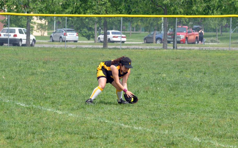 Vicenza left fielder Celist Jiminez fields an Aviano hit Saturday in a softball doubleheader at Aviano. The Cougars won the second game 16-12 after falling to the Saints 7-4 in the opener.