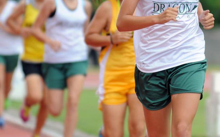 Kubasaki sophomore Allie Reichenberg leads the pack in the 3,000-meter run during Saturday's 23rd Okinawa Activities Council district track and field championships at Okinawa City Stadium, Koza, Okinawa. Reichenberg demolished the old record of 12:07 by clocking a time of 11 minutes, 29.87 seconds, the first of her four titles in district meet record-breaking time.