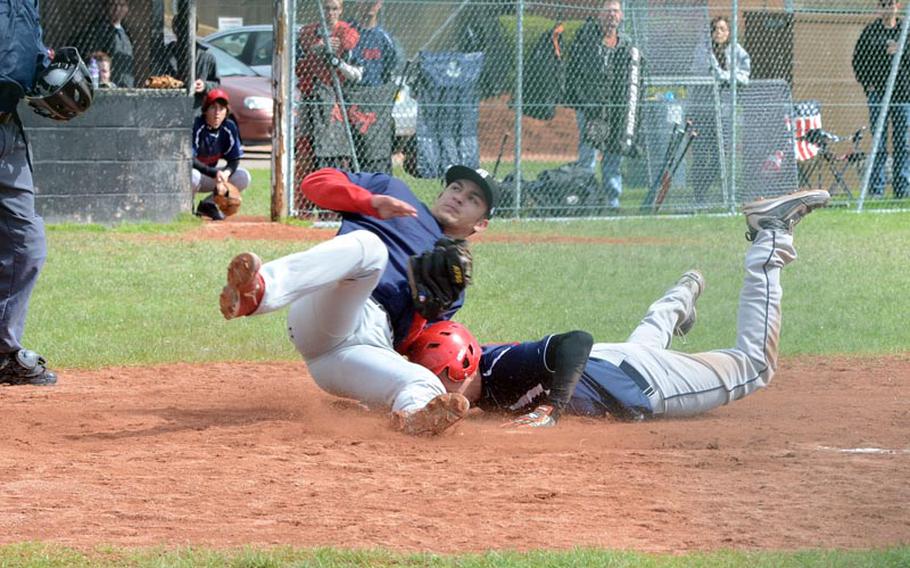 Bitburg pitcher Austin Schmidt tags Lakenheath's Kyle Capogna out at home plate during Game 1 of a doubleheader, Saturday, at RAF Feltwell, Engalnd. Bitburg lost both games by a single run (3-2, 14-13).