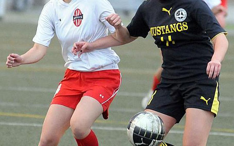 American School In Japan's Isabella Loose, right, and Nile C. Kinnick's Mari McDonald battle for the ball during Friday's Kanto Plain Association of Secondary Schools girls soccer championship match at Yokosuka Naval Base, Japan. The host Red Devils blanked the Mustangs 1-0 for their first Kanto title since 2008 and their fifth in 13 seasons.
