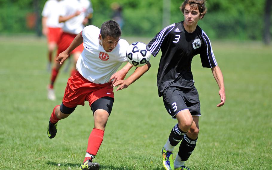 Kaiserslautern's Anthony Caceres heads the ball as he drives upfield against Ramstein's Troy Guffey. The final game of the regular season ended 1-1 in Kaiserslautern, Saturday.