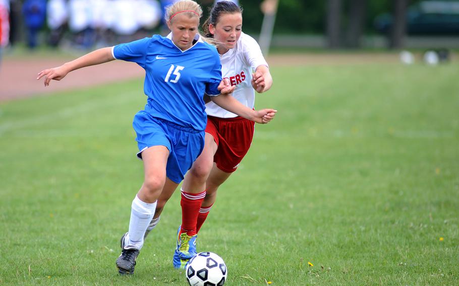 Ramstein's Victoria Coleman drives the ball upfield against Kaiserslautern's Brie Scott  in a game of undefeated teams in Kaiserslautern, Saturday. Ramstein won 1-0 to take the Region II title going into the European championships that begin May 21.