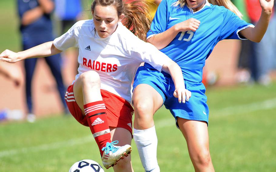 Kaiserslautern's Arianna Osmar, left, and Ramstein's Victoria Coleman  fight for the ball in a Region II game in Kaiserslautern, Saturday. Ramstein ended the regular season undefeated after handing the Raiders their only loss with a 1-0 win.