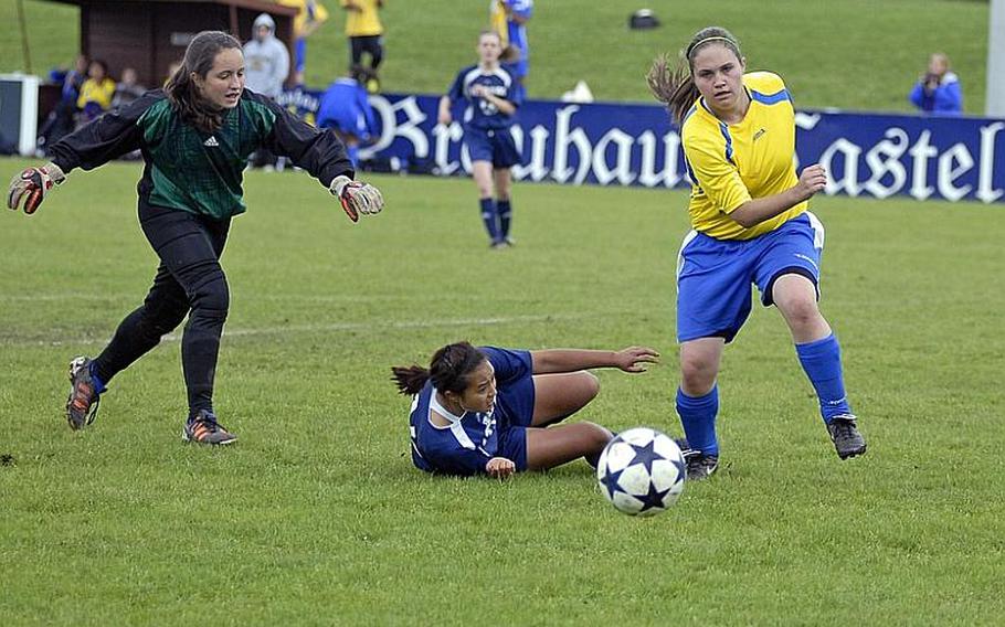 Wiesbaden sophomore defender Mackenzie Jefferson and freshman keeper Rebecca Russell chase down the ball as Bitburg senior Klea Bajala watches from the ground during a soccer match, hosted by Wiesbaden, on Saturday. Wiesbaden won the game, 4-0.