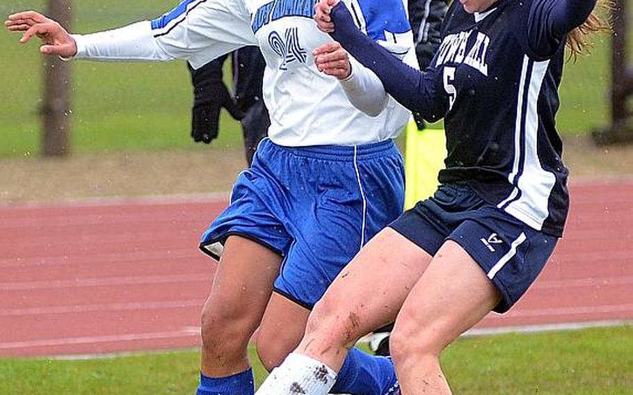 Menwith Hill's Samantha Cubbler (right) tries to break up an offensive run by Rota's Gabby Rivera at RAF Alconbury, England in April. Cubbler scored the only goal of the match to lead the Mustangs to a 1-0 victory. Menwith Hill is seeded second and defending champ Rota is third in Division III when the DODDS-Europe soccer championships get under way Monday.